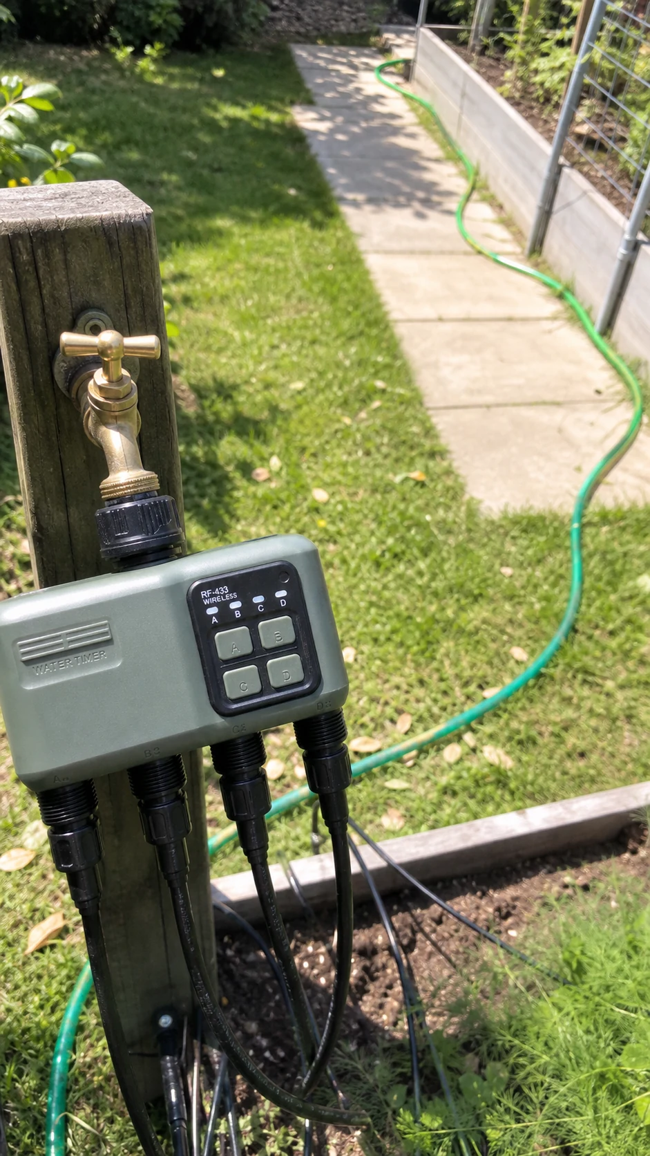 Four-zone smart water timer feeding separate garden irrigation lines